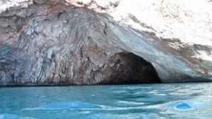 Visit Rina Cave, which is located by an unspoiled beach with exotic green water