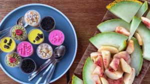 Tasting a variety of desserts and fresh fruits.