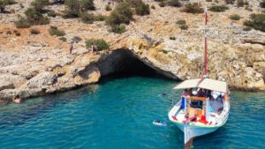 Cliff dive in the turquoise water outside of Rina’s sea cave